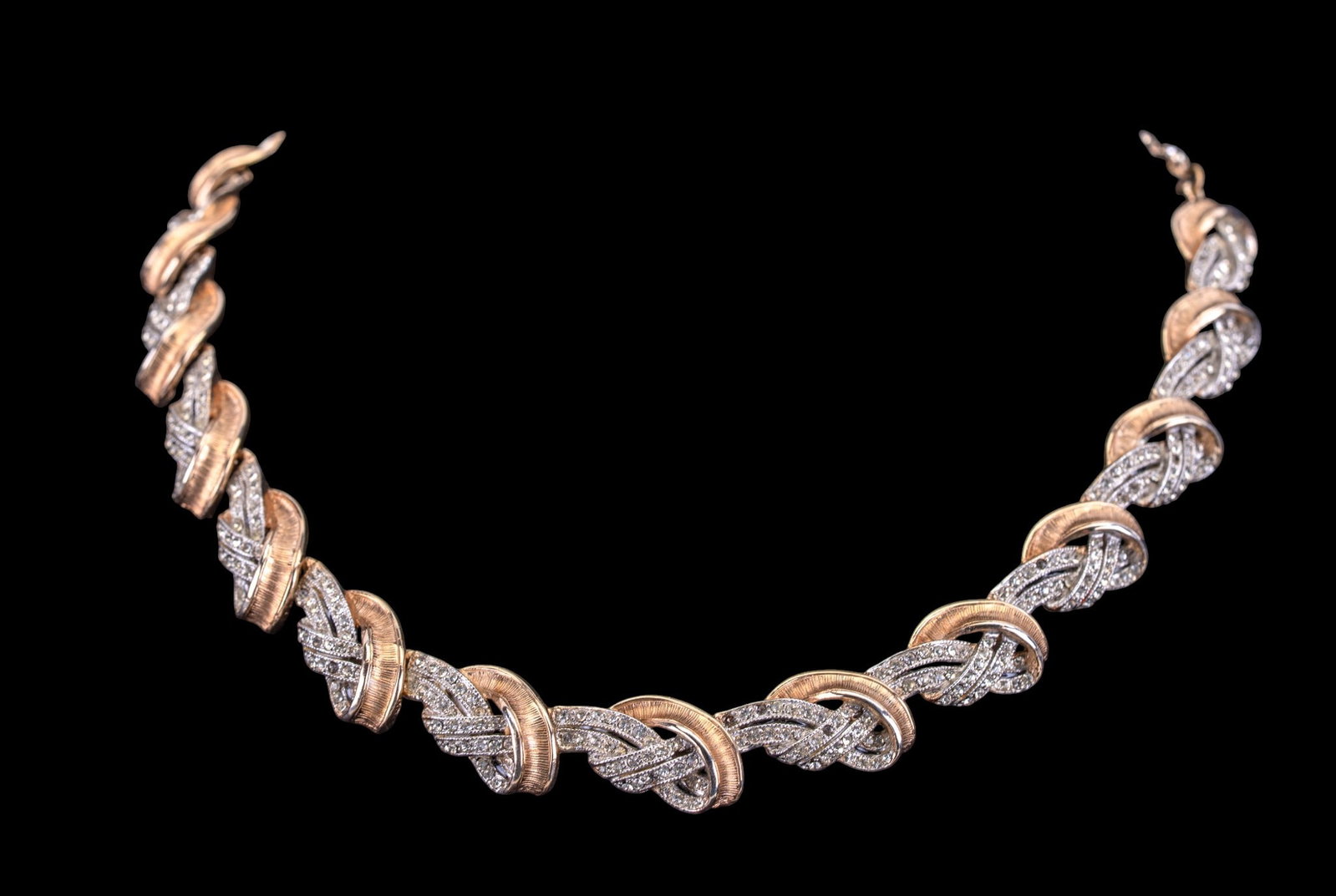 Hattie Carnegie Necklace: Gold and silver-tone rhinestone necklace, signed Hattie Carnegie.