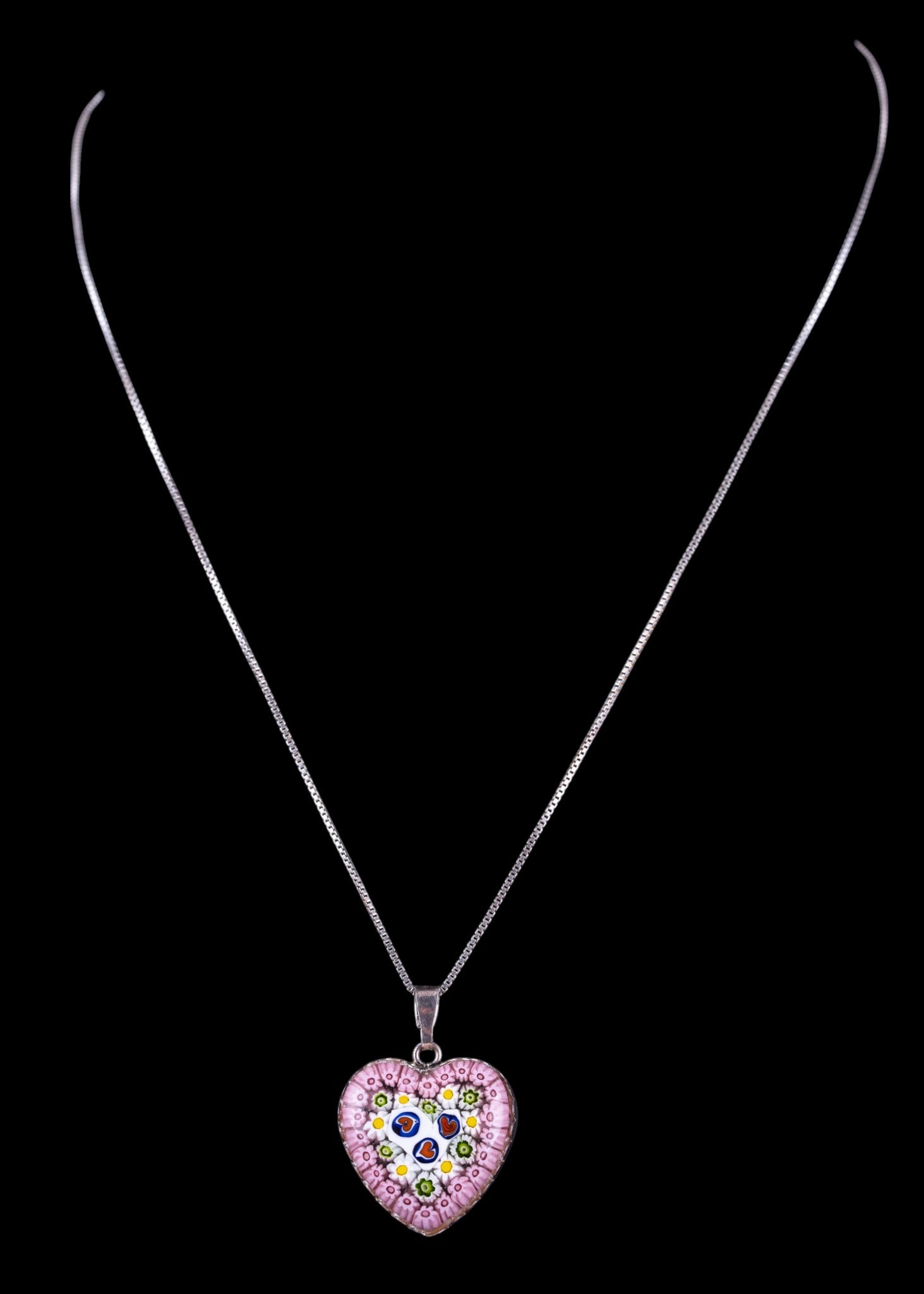 Murano Millefiori and Sterling Pendant Necklace: An Italian crafted sterling silver pendant featuring Murano blown glass art millefiori in a heart shape, with sterling box chain, measuring approx. 8.5" L on the drop. Total weight is approx. 0.25oz.