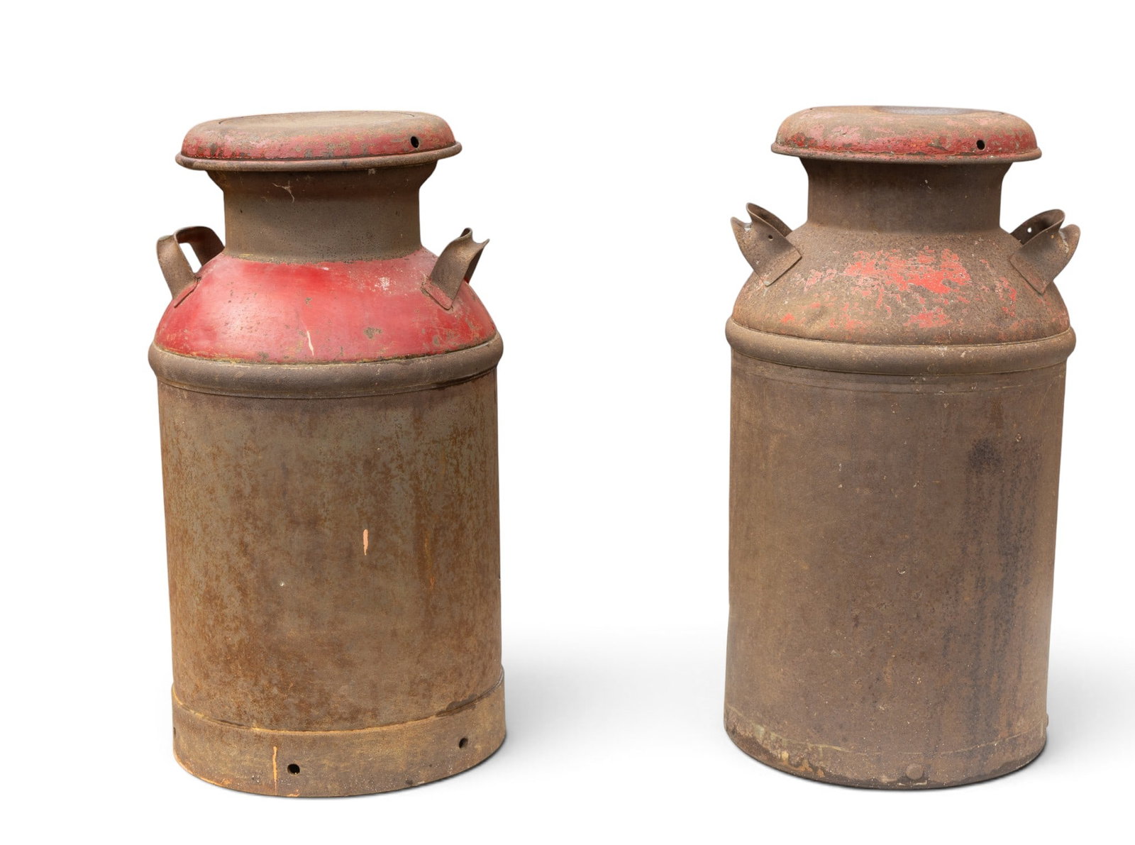 2 Metal Milk Cans, 25 Inches Tall: Two metal presumed galvanized iron milk cans, each measuring approximately 25 inches in height and 13.5 inches in diameter. Both cans feature red painted tops with visible patina and carry handles on