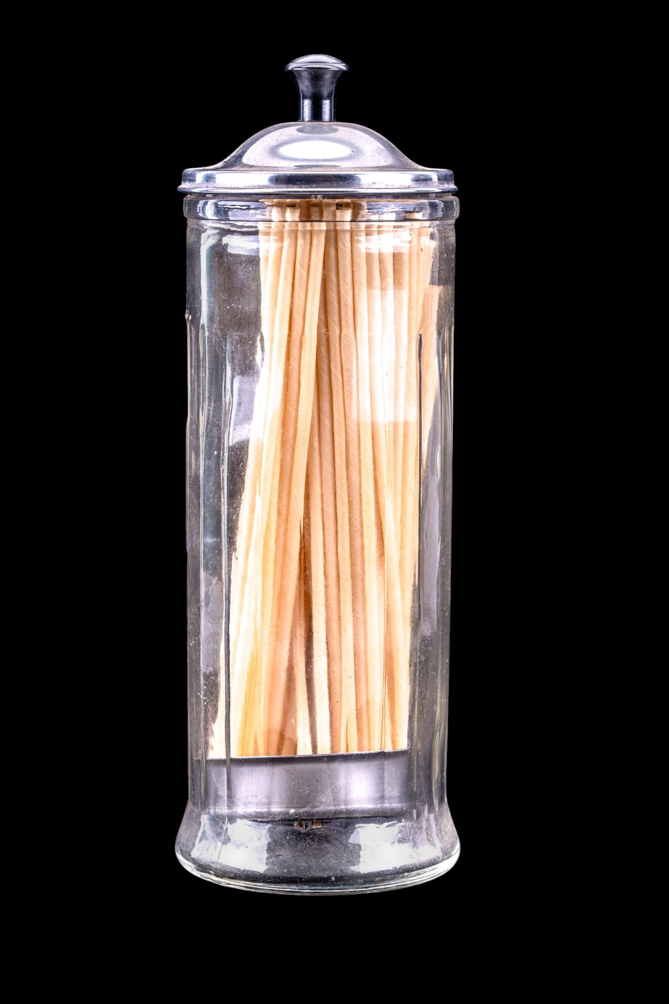 Vintage Glass Straw Holder With Metal Lid: This is a vintage straw holder made of clear glass with a metal lid and dispenser mechanism. The holder is designed to organize and dispense drinking straws efficiently. It displays a classic style co