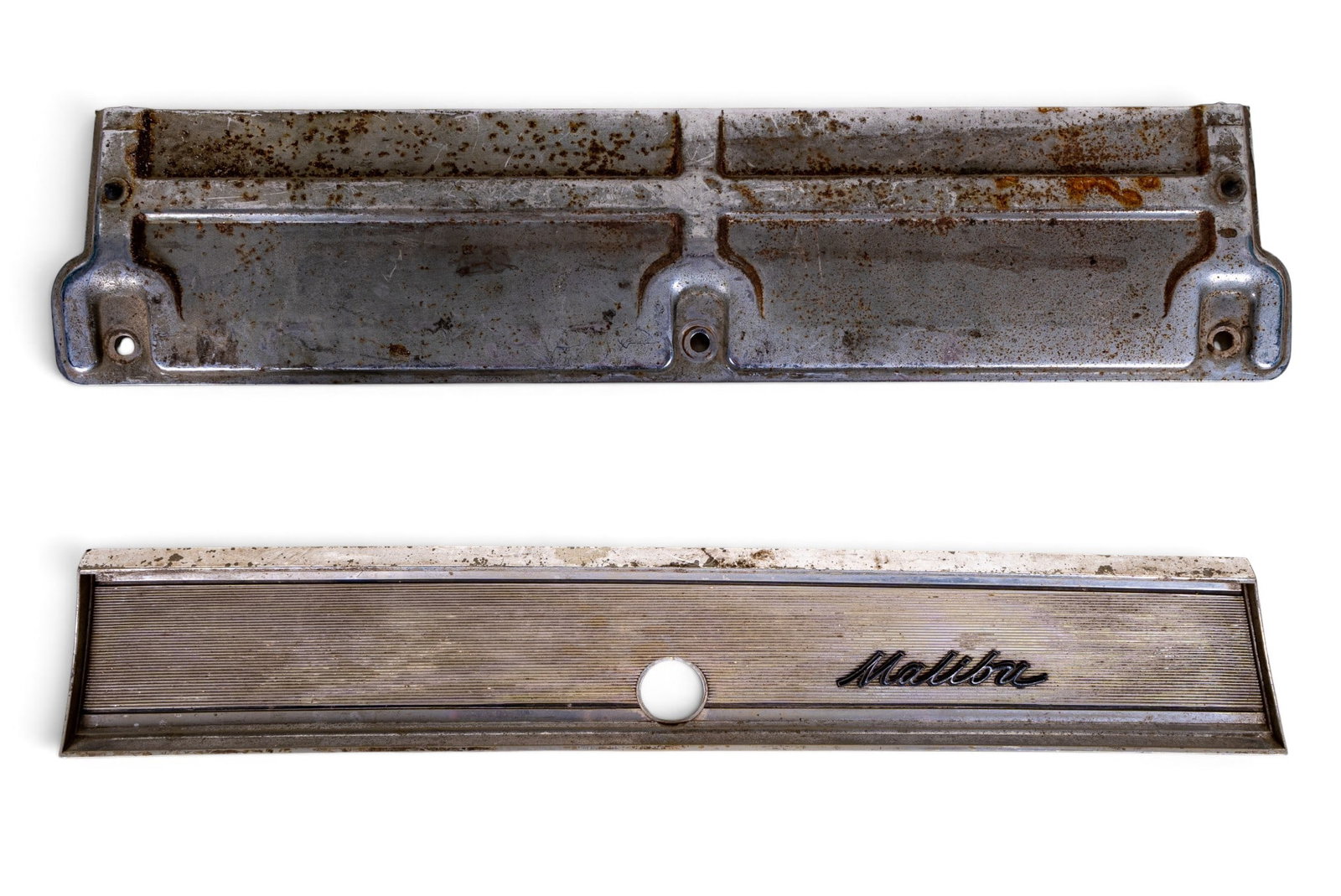 Chevrolet Malibu Metal Trim Panel: Chevrolet Malibu metal trim panel. Features the Malibu script and mounting brackets on the back, with signs of rust and wear on the reverse side. Original automotive part. Measures approximately 24"