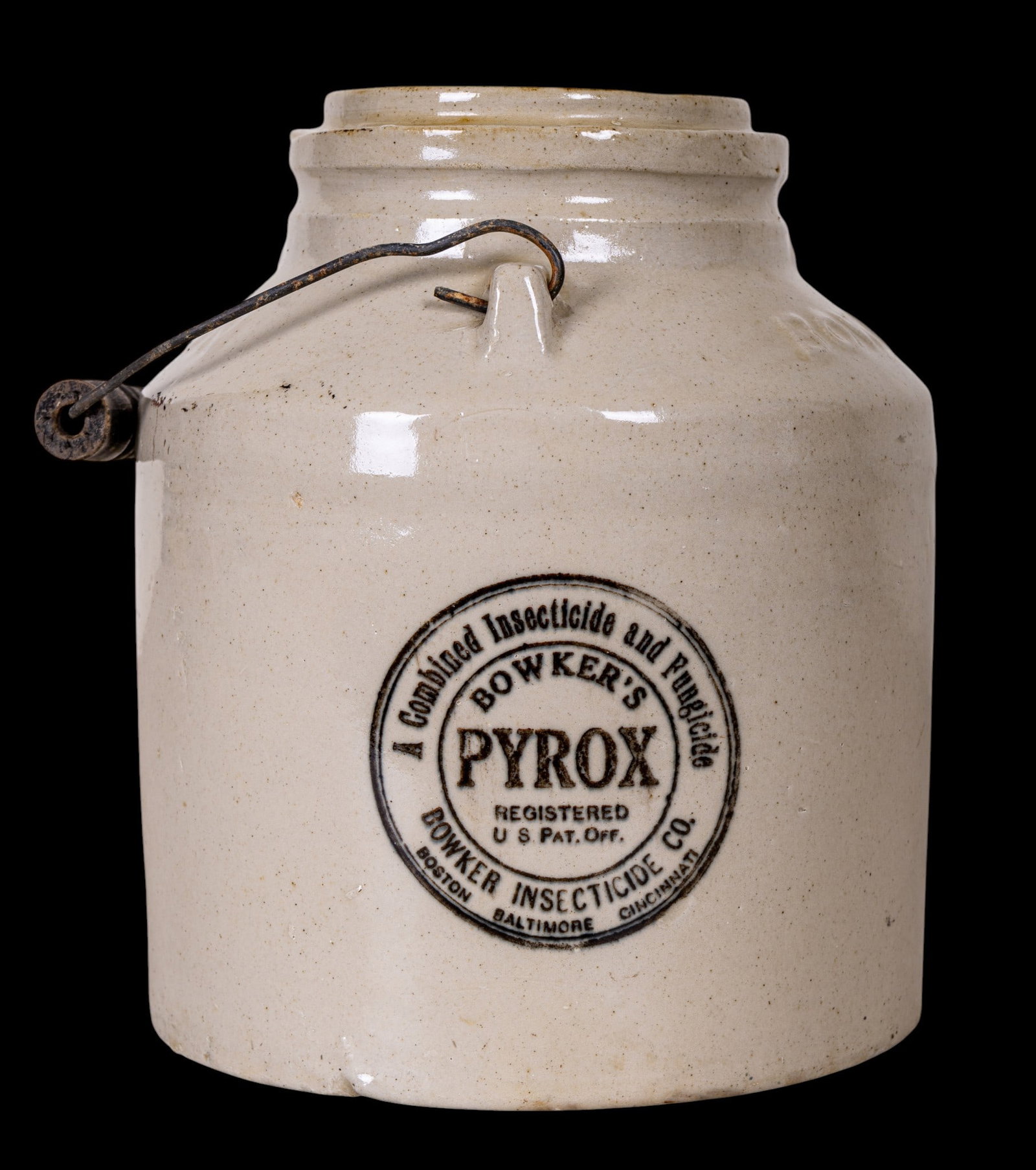 Bowker's Pyrox Stoneware Insecticide Jug: Bowker's Pyrox stoneware jug for insecticide and fungicide, with embossed words "BOWKERS" and "POISON." Features original label, wooden handle, and measures approximately 7" dia x 8.5" H, 11.5" H