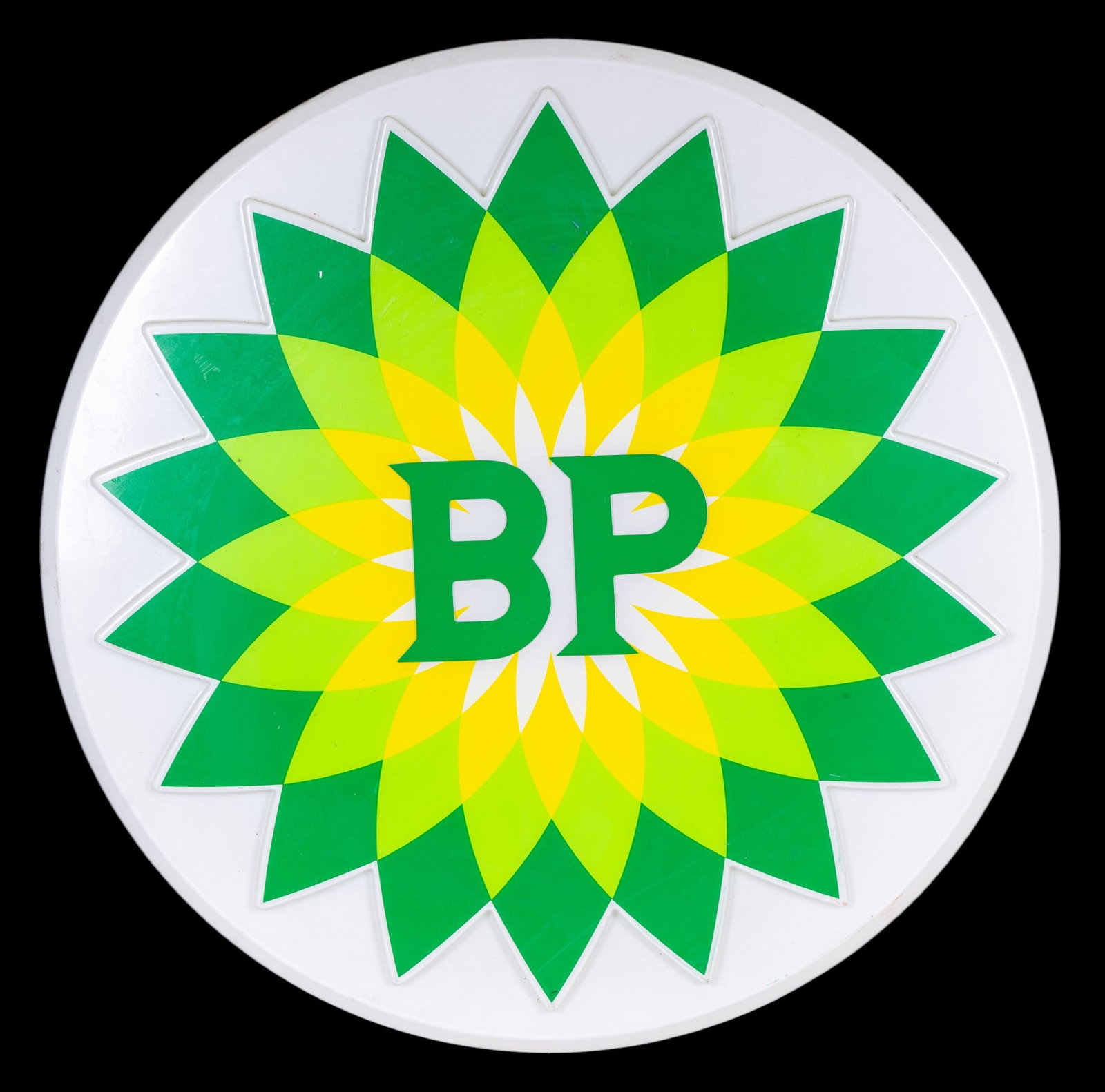 BP Illuminated Round Advertising Sign: BP (British Petroleum) branded illuminated round sign featuring the green and yellow 'Helios' logo. Constructed from molded plastic with a metal rear panel and a built-in electrical cord. Power cord i