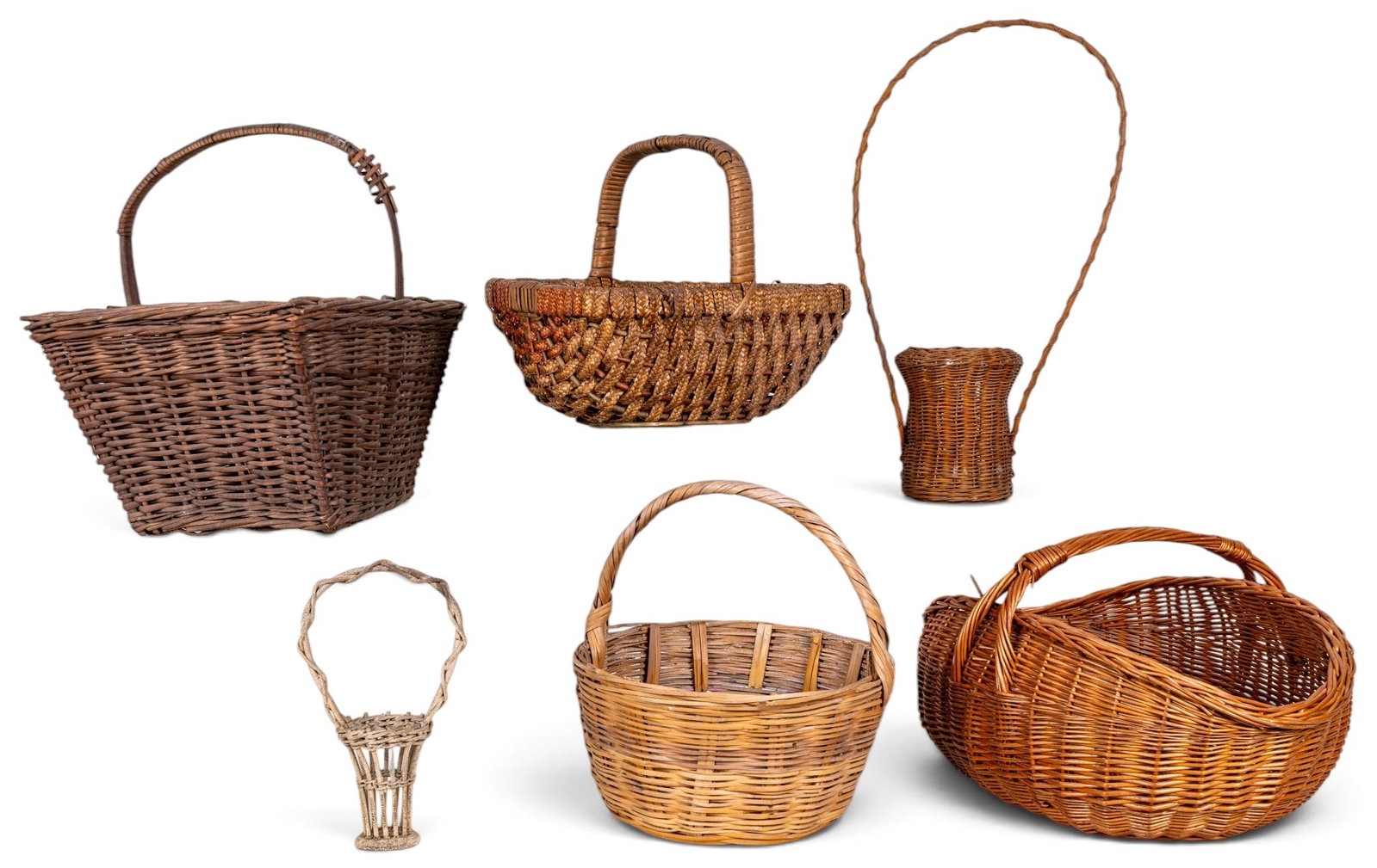 Woven Baskets, 6 Assorted Styles: Six assorted woven baskets in various shapes, sizes, and ages. Some constructed from natural wicker and reed materials. The grouping features round, oval, and rectangular baskets, each with unique