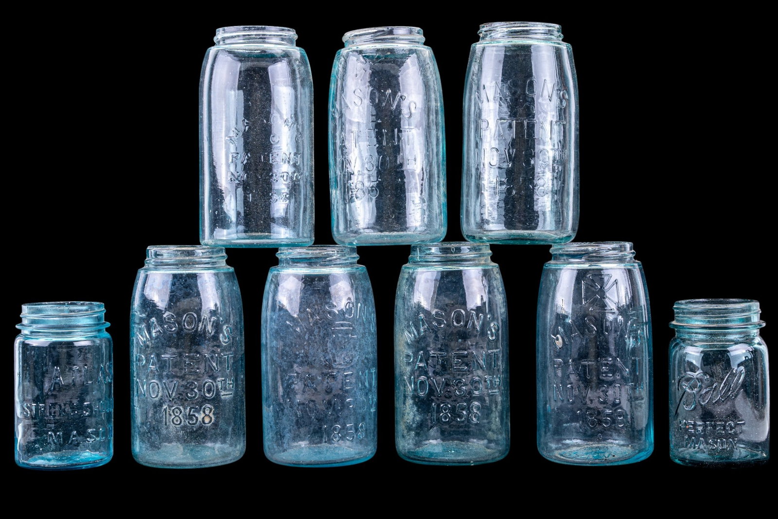 Mason's Jars & Ball Perfect Mason Jars Lot (9pcs): Nine clear and aqua glass jars including multiple MASON'S PATENT NOV 30TH 1858 jars and a Ball Perfect Mason jar. Various embossed markings on bases. Condition consistent with age and prior use.