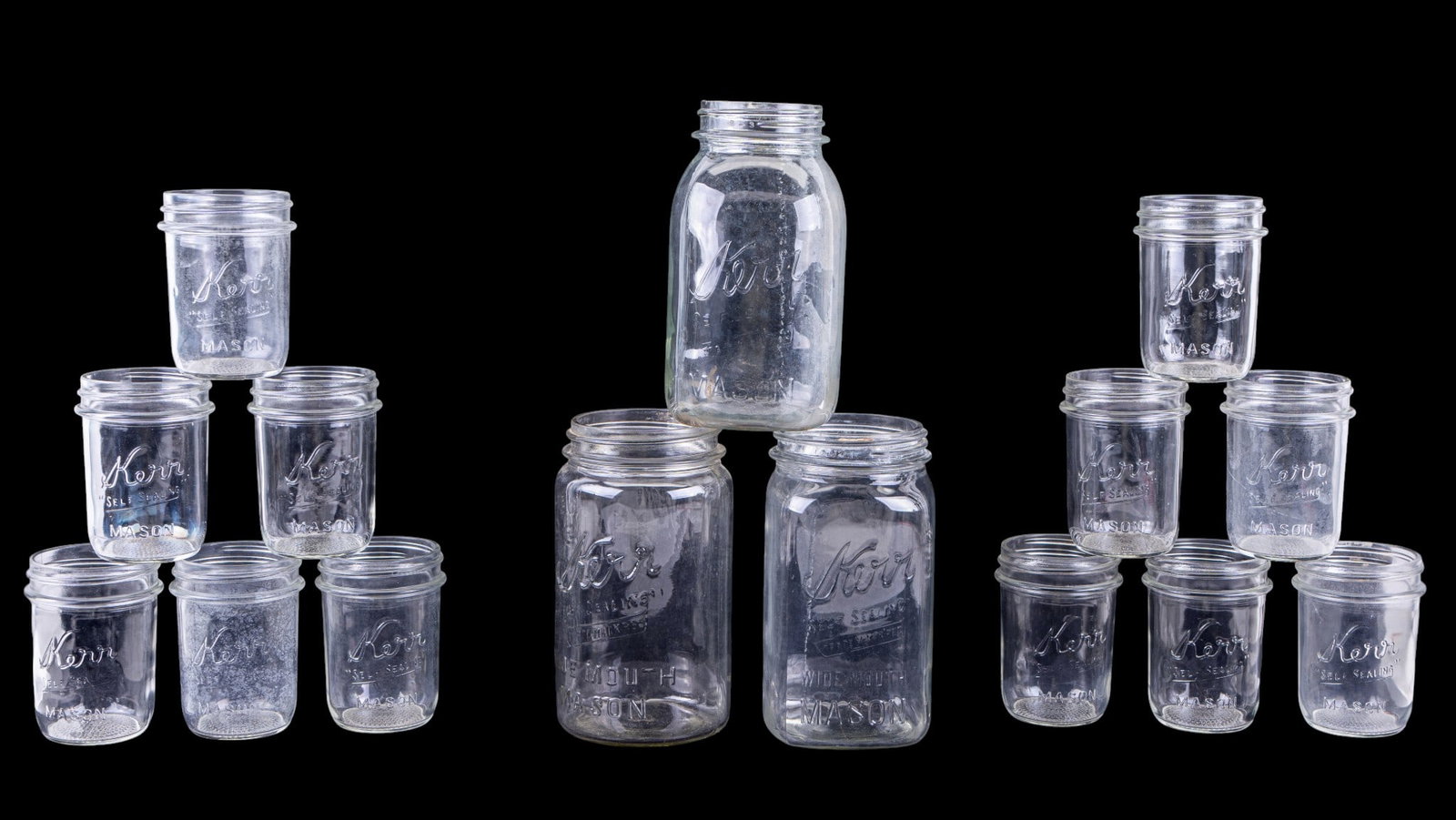 Kerr Glass Mason Jars Set of 15, Assorted Sizes: 15 Kerr glass Mason jars including two matching wide mouth large jars, one slightly smaller large jar, and 12 matching smaller jars. All jars are clear glass with embossed Kerr branding and various