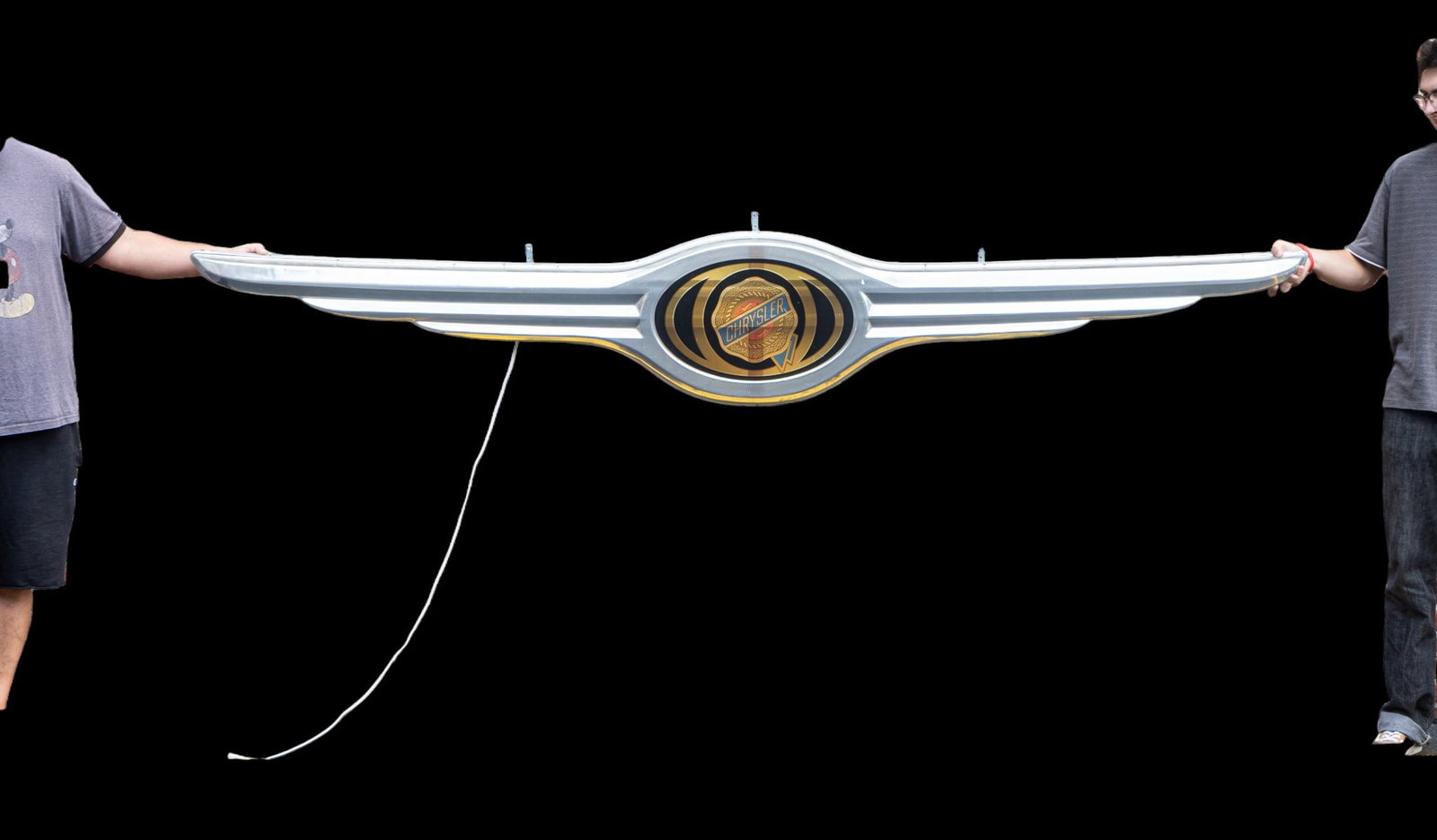Large Chrysler Illuminated Sign: Large Chrysler illuminated sign measuring approximately 114.5 inches in length. The sign includes a plastic frame made to look like chrome-tone metal with the Chrysler logo in gold and black and