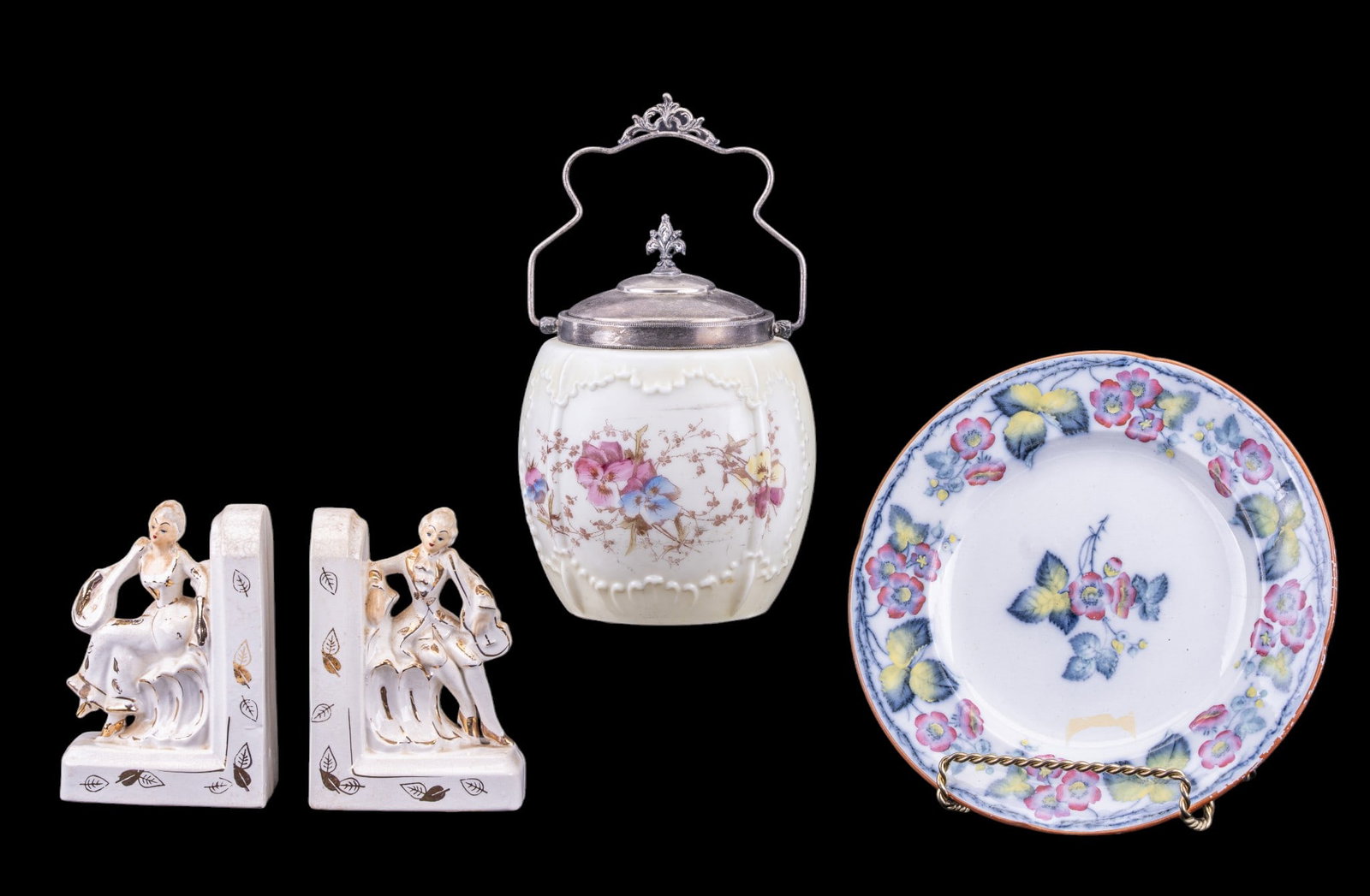 Porcelain Figural Bookends, Ice Bucket, Plate: Decorative porcelain plate marked 'Blossom' with a floral motif, a pair of porcelain bookends with gold accents featuring figurines, and a glass ice bucket with a metal lid and handle, decorated with 