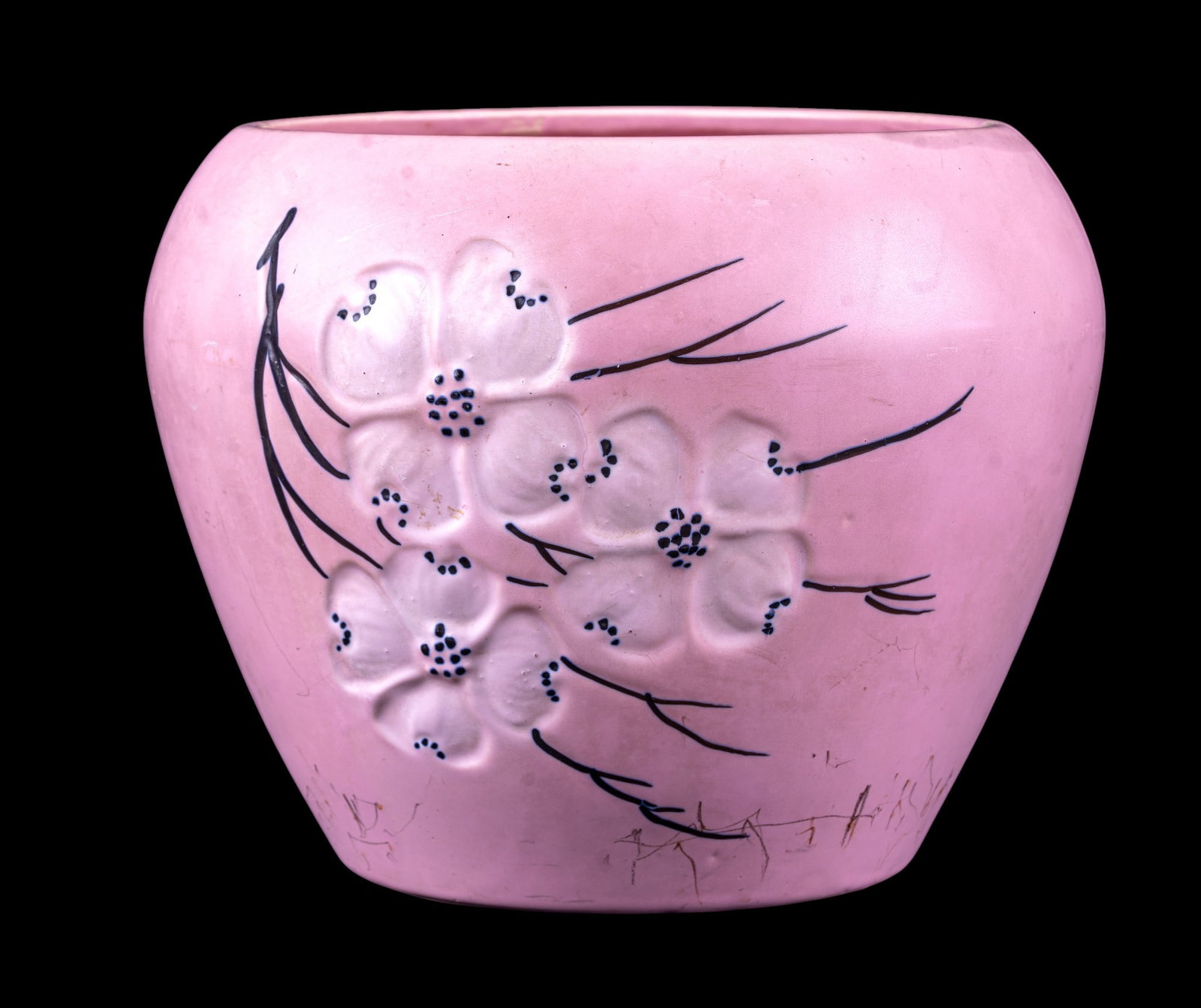 McCoy USA Pink Dogwood Pottery Vase: McCoy USA pottery vase in pink glaze, featuring raised white dogwood flower decoration. Rounded bowl shape with open mouth. Marked 'McCoy USA' on underside of base. Likely mid-20th century American ar