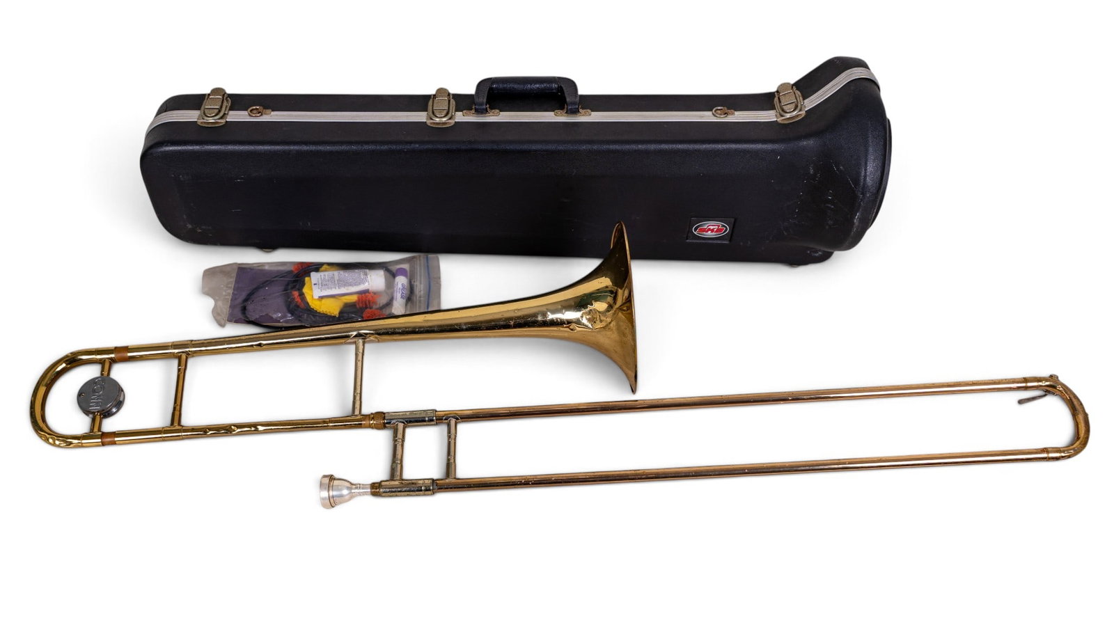 Conn Director Trombone in Hard Case w/ Kit: Conn Director trombone featuring brass construction with 'Conn' emblazoned tuning slide and Conn 12C mouthpiece. Includes hardshell SKB case and Yamaha trombone maintenance with slide grease,