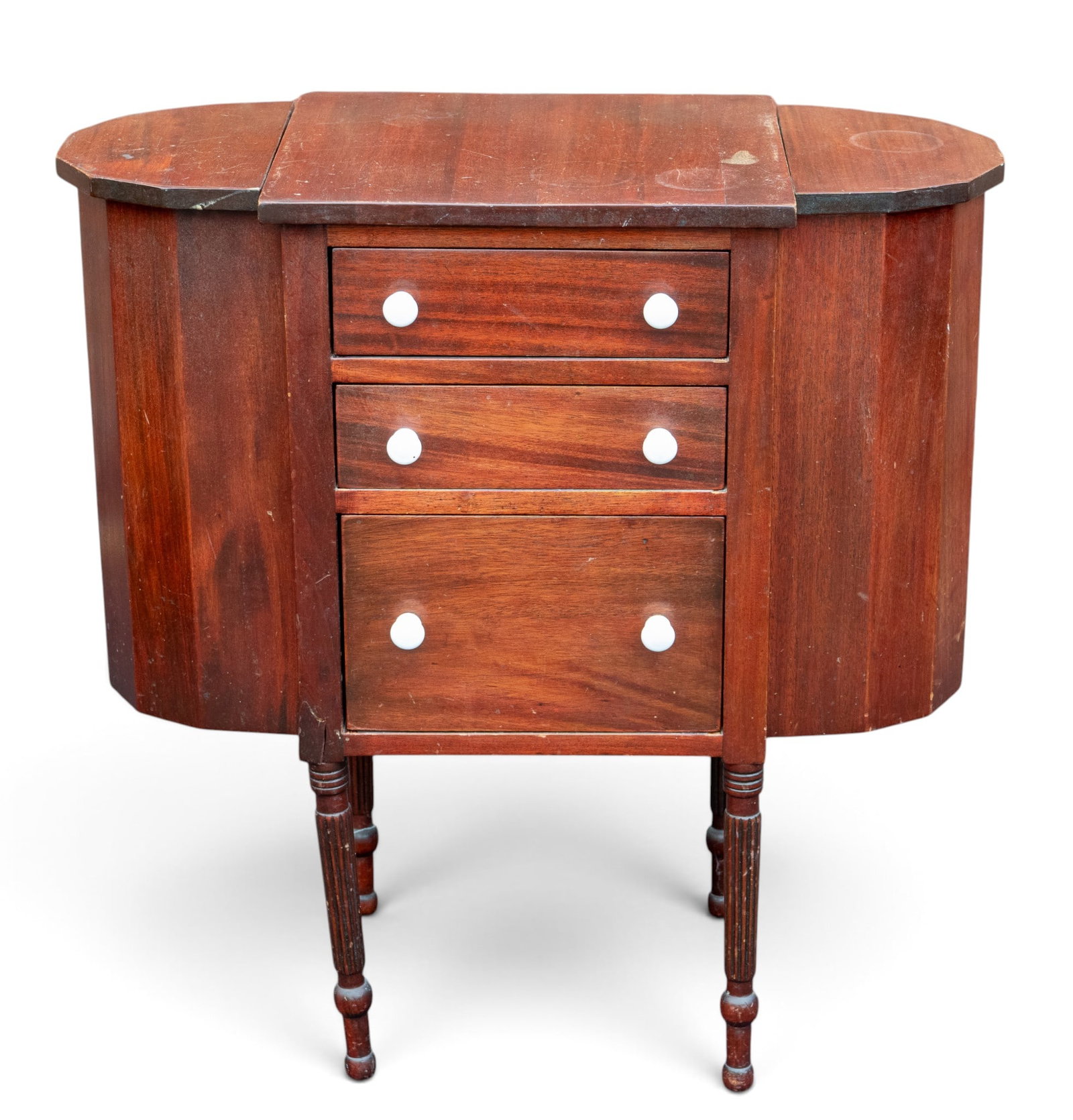 Martha Washington Sewing Cabinet: A Martha Washington style sewing cabinet featuring porcelain drawer pulls and dovetail joinery, note right front leg will require repair. Measures approx. 28" W x 14" D x 29" H.