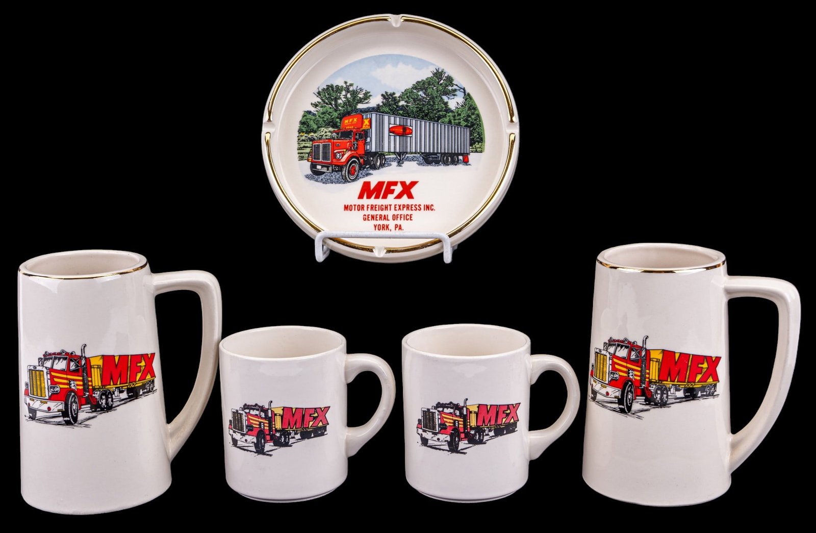 MFX Steins, Mugs, Ashtray: MFX themed table articles comprising 2 matching MFX steins with truck imagery and gilt rims, two MFX mugs, and a MFX Motor Freight Express inc. gilt-rimmed ashtray. Ashtray measures approx. 6.5" Diame