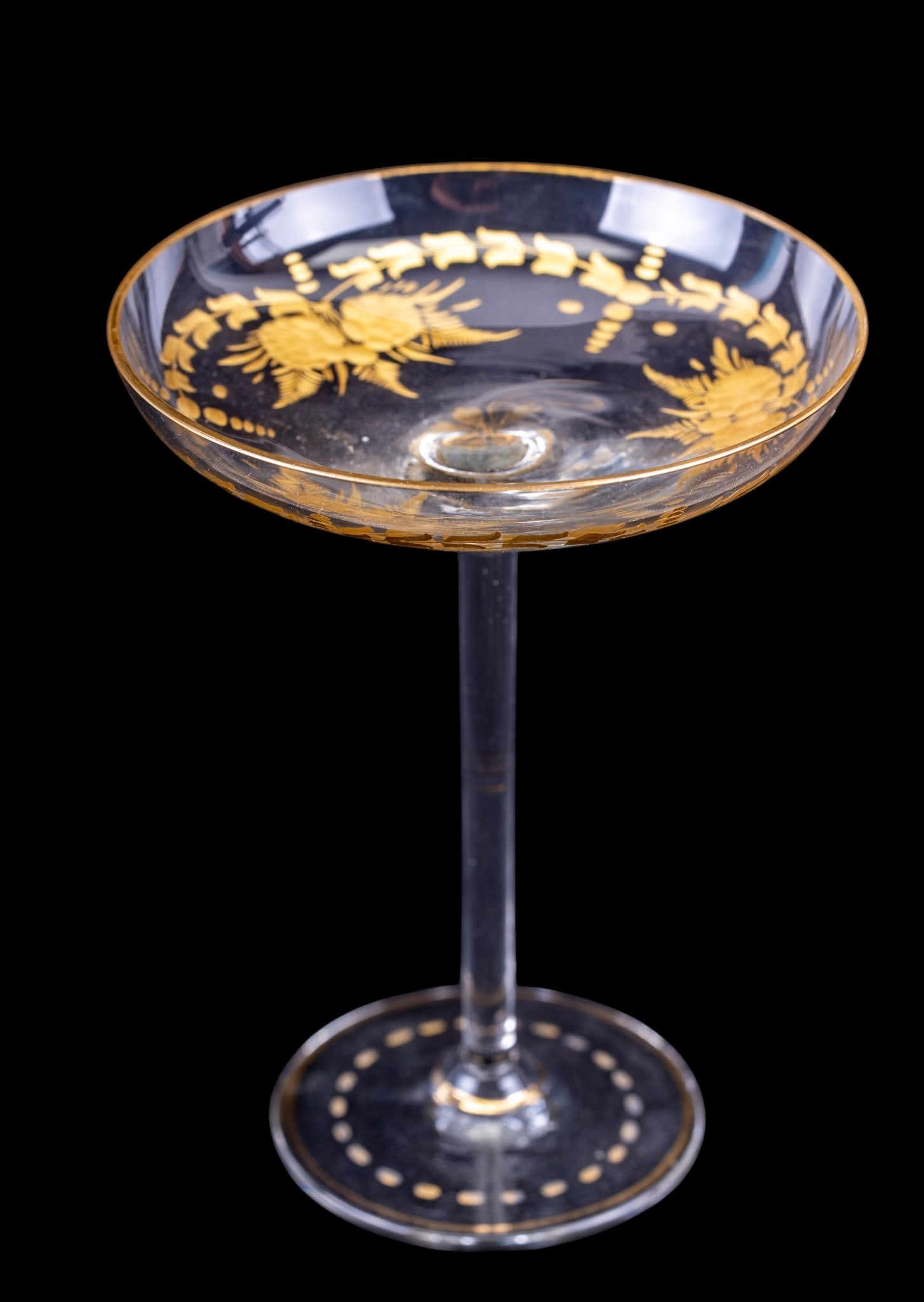 Bohemian Moser Cut and Gilt Glass Compote: A Bohemian Moser clear cut and gilt glass compote featuring a floral pattern, measures approx. 5.5" diam x 7.25" H. Note some paint loss on the base.