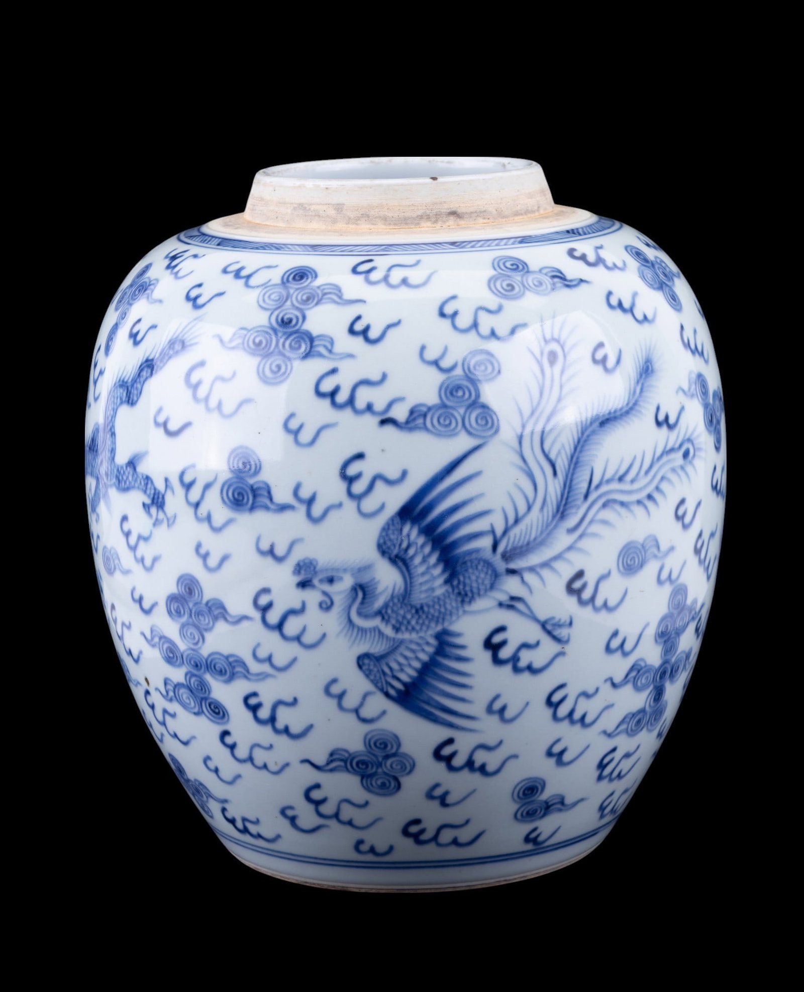 19th C Blue & White Porcelain Ginger Jar: A blue and white porcelain ginger jar with swirl design, phoenix and dragon motifs. Lid not included. Jar measures approx. 10" H. Appears to have a pottery flaw from manufacturing in interior not visi