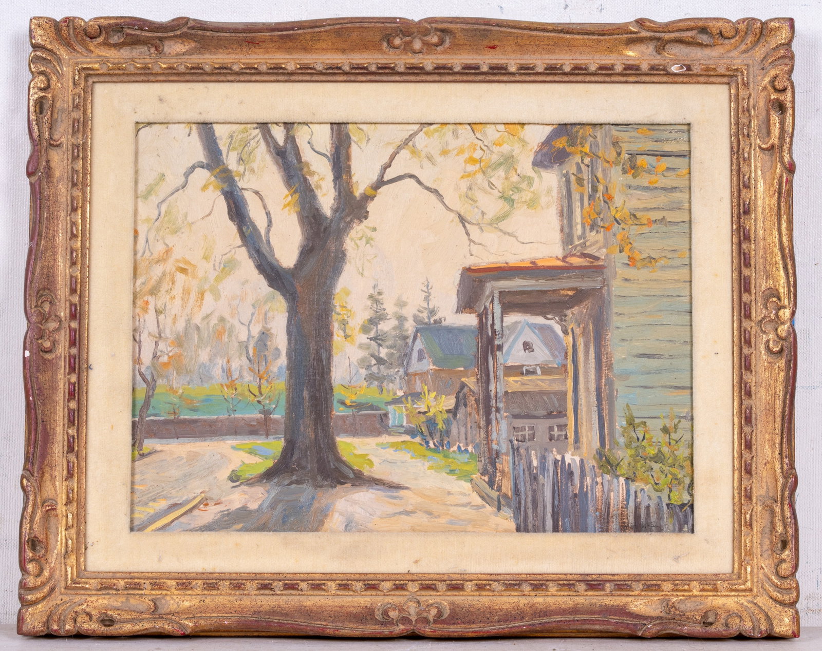 Impressionist Oil on Board attr John Howell: An oil on board painting depicting a nearly bare autumn tree in front of a row of houses, signed very faint in the lower right corner by a New Jersey artist, attributed to the work of John S. Howell. 