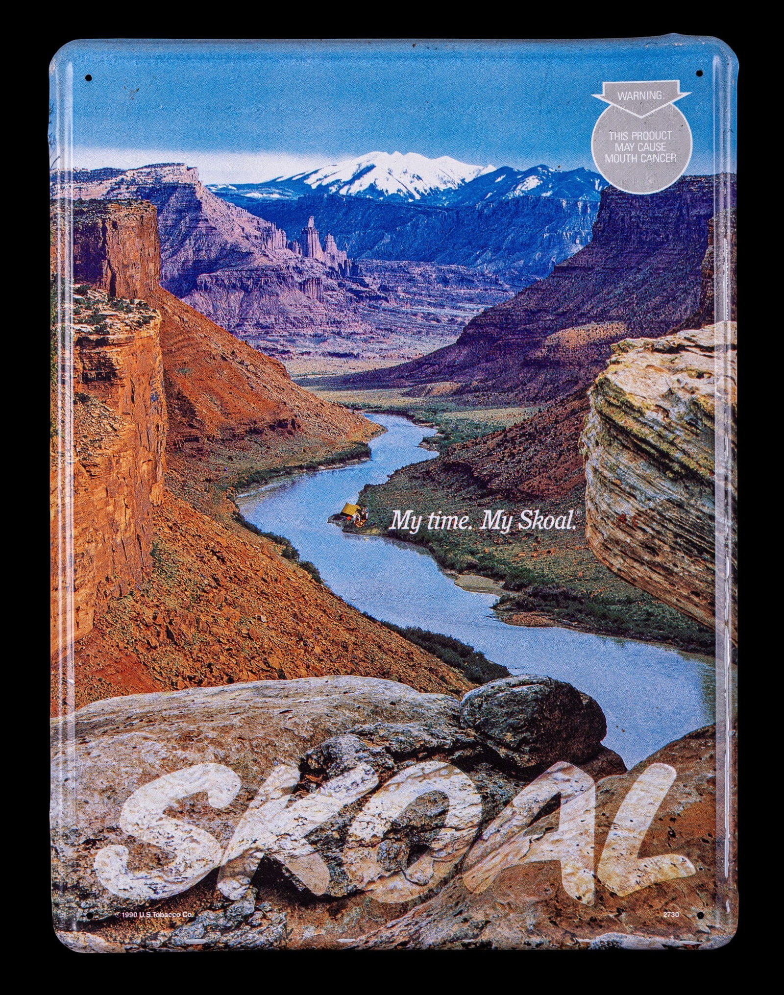Skoal Metal Advertising Sign 11.5" x 16": Skoal metal advertising sign measuring 11.5 inches by 16 inches. Features a scenic landscape design with Skoal branding and product warning. Suitable for display or collection purposes.