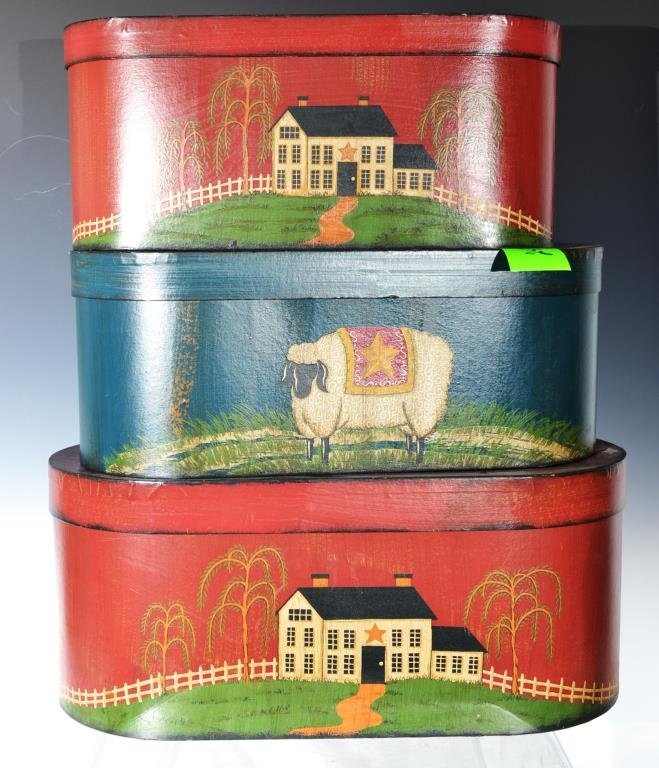 Grouping of Folk Art Boxes: Three Folk Art boxes (two with a farm, one with a wooly ram) in the antique style; three boxes stacked measures 24" H