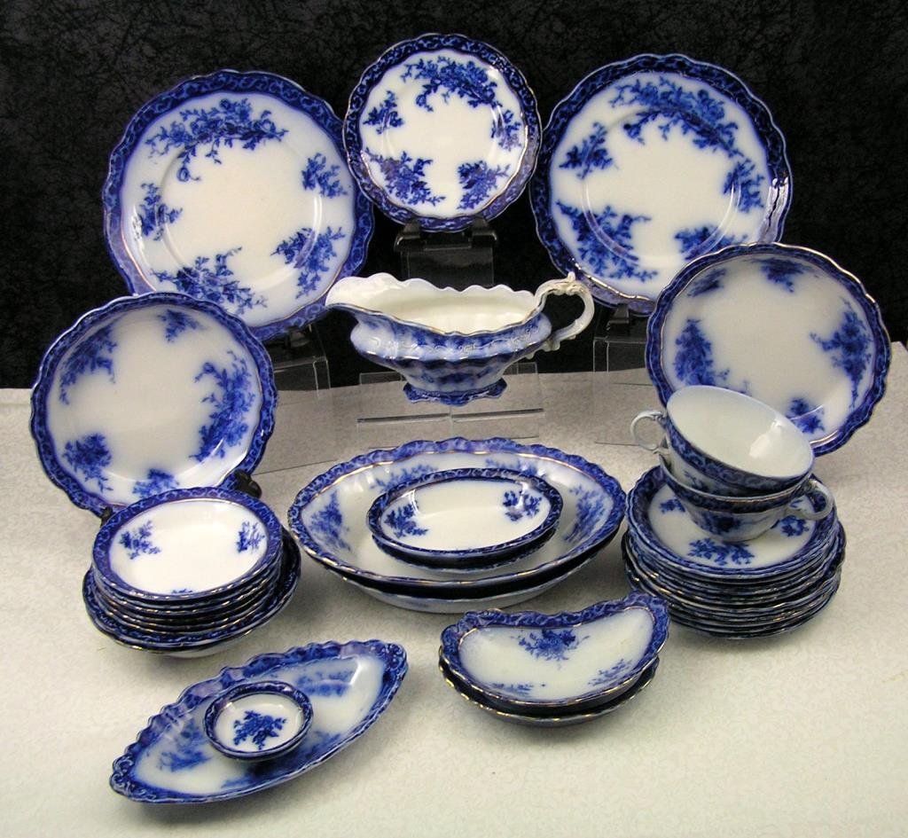 Lot Staffordshire Touraine Flow Blue China Partial: Lot Staffordshire Touraine Flow Blue China Partial Dinner Service Condition Report: Sitzendorf candlestick has a broken area to the rim where the candlestick is placed, Limoges bowl has several chips