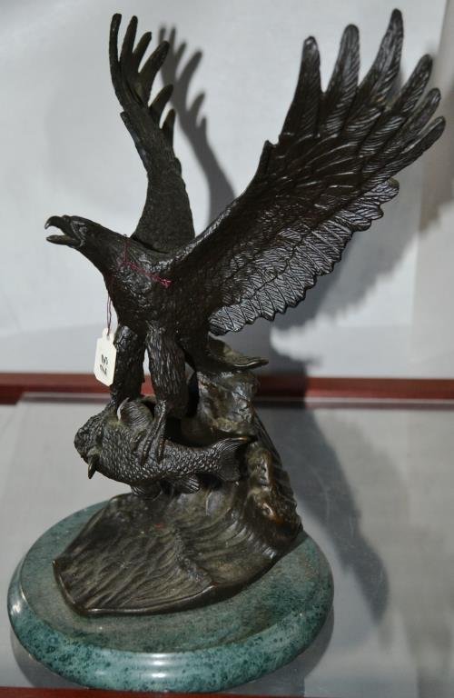 Bronze Sculpture of an Eagle in Flight: Bronze sculpture of bald eagle in flight, holding a statue; mounted on a polished marble base, measures 10"h x 8"w
