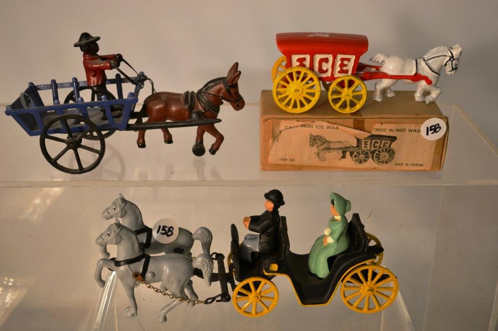 Cast Iron Horse Drawn Vehicles: Cast Iron horse drawn ice wagon with white horse, in original box, as well as a blue mule-drawn hay wagon with an African American multeer, and a fancy wagon with a matched pair of grays and a passeng