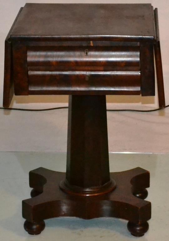 Mahogany Two Drawer Work Table: Mahogany two drawer work table with two crotch grain mahogany drawer fronts, with eight sided stem on a pedestal base on turned feet, circa 1840 measures 27"h x 33.5"w (open) x 17"w (closed) and 18"d