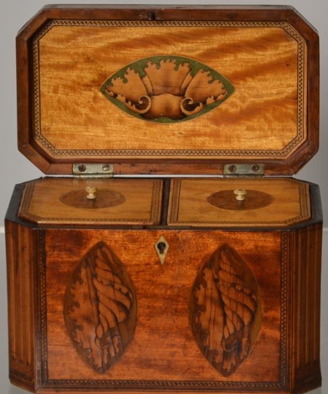 English Satinwood Tea Caddy c 1800: English satinwood conch shell inlaid Tea Caddy with canted corners, two satinwood inlaid conchs on the front, one satinwood conch on the lid; circa 1800, measuring 7.5 inches