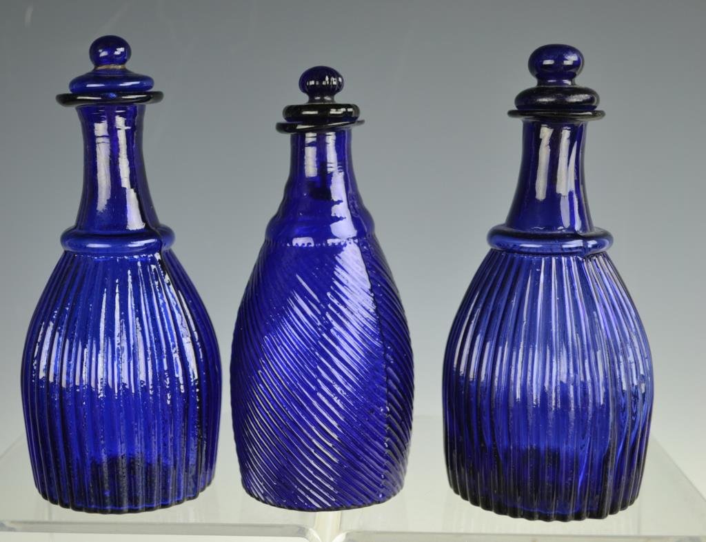 Three Molded American 19th C Decanters With Stoppe: Three molded American cobalt blue 19th C decanters, two with vertical ribs and the third with swirled ribs, all with pontil scar, largest is approx 6.5"h