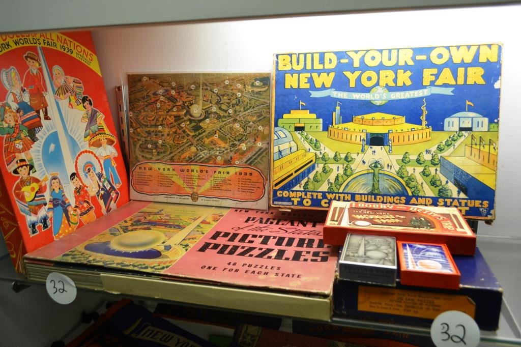 Games and Puzzles from the 1939 New York Worlds Fa: Games and puzzles grouping includes; two deck of cards, Bobby & Betty's Trip, a wood jigsaw puzzle "Interior of the Perisphere", "Build Your Own New York Fair" paper dolls of all nations, Sloan's Lini