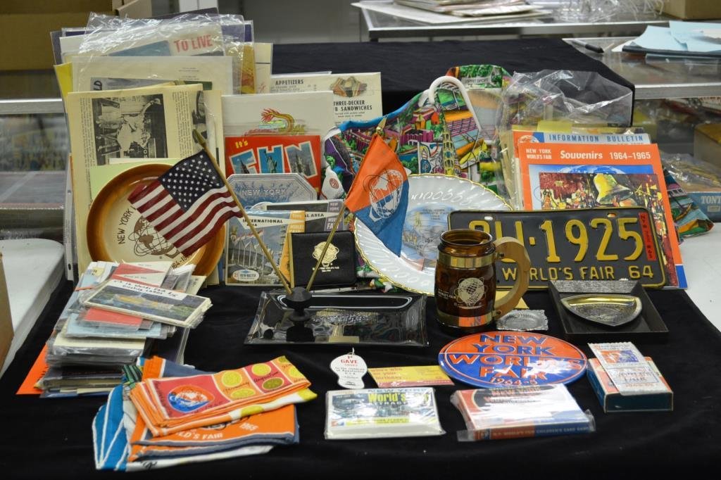 Large Grouping of 1964 Worlds Fair Items: includes white milk glass plate, "Pieta" book, children's card games and flash cards, hankies, glass tray, wall plaque, early advertising and menus "Chung King" canned Chinese food and a menu with Cok