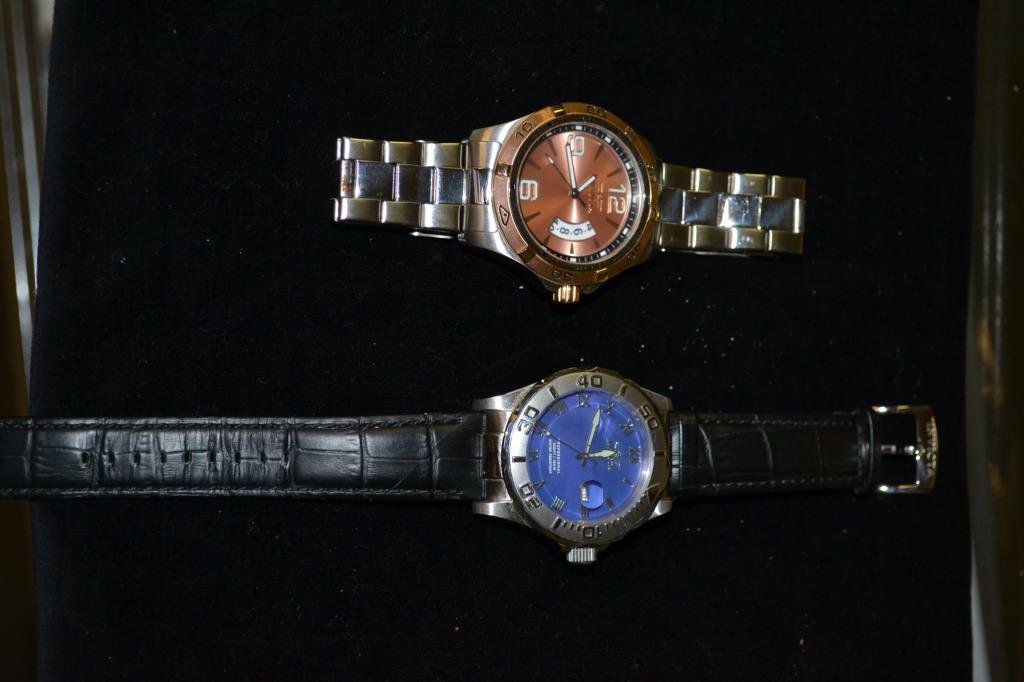2 Invicta wrist watches.: Specialty Collection, Making History, Trinite, nightglow, stainless with copper colored face & 1708, black leather band, blue face.