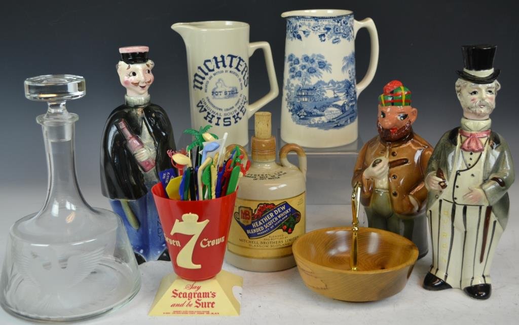Collection of Advertising Items: Advertising items include a Segram's 7 crown whiskey vessel, collection of cocktail stirrers, three figural decanters, Heather Dew whiskey bottle, glass eagle decanter, and more