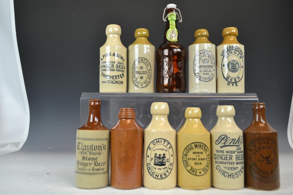 Collectino of 10 Advertising Stoneware Bottles: Advertising stoneware bottles including; Harlech Mineral Water, F. Chitty, J. Mills and Sons of London, Pink's Ginger Beer, PortMadoc Mineral Water, Clayton's Ginger Beer, R. M. Bird and Co Ginger Bee