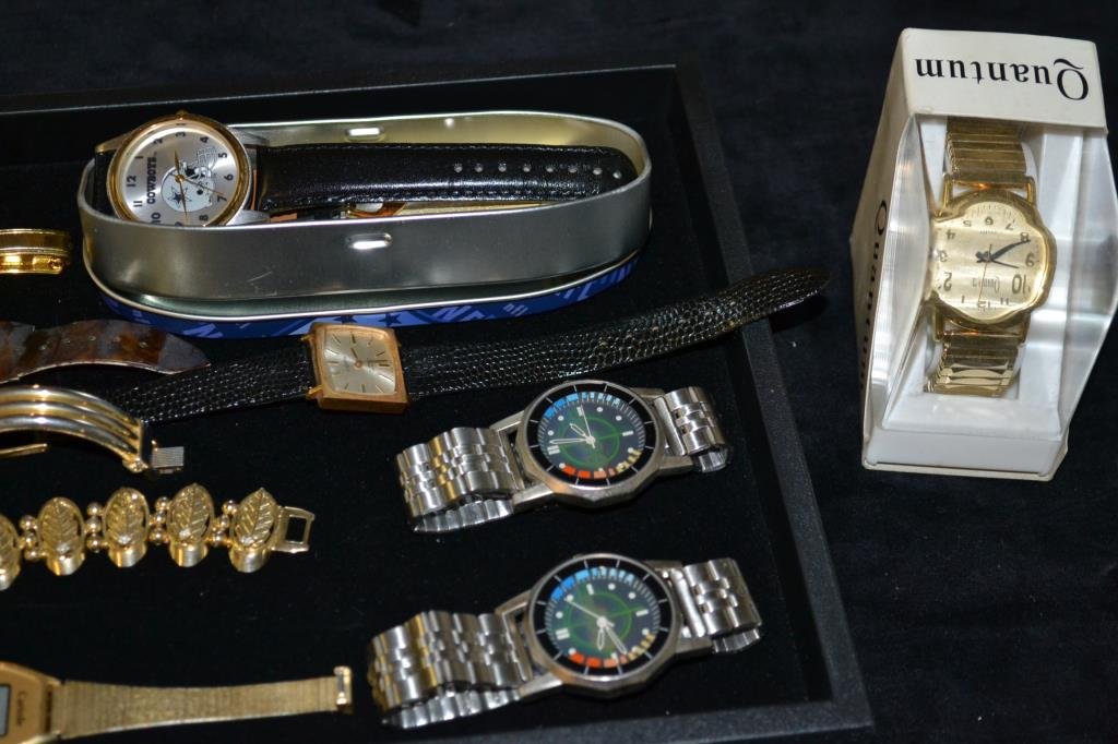 Watch Lot: Includes a new in box Quantum, a Dallas Cowboys Watch in tin, two 007 hologram watches, Luxor 17 Jewel, a Cariole Solar, Piaget, Pieve Nicol, Laussanne, and a Le Baron.
