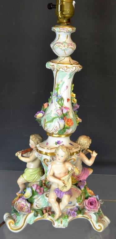 Meissen Candlestick/Lamp: Meissen candlestick converted to lamp with early blue cross sword marks, ornately decorated with flowers and children playing instruments (missing 2 flower petals, leg, fingers)