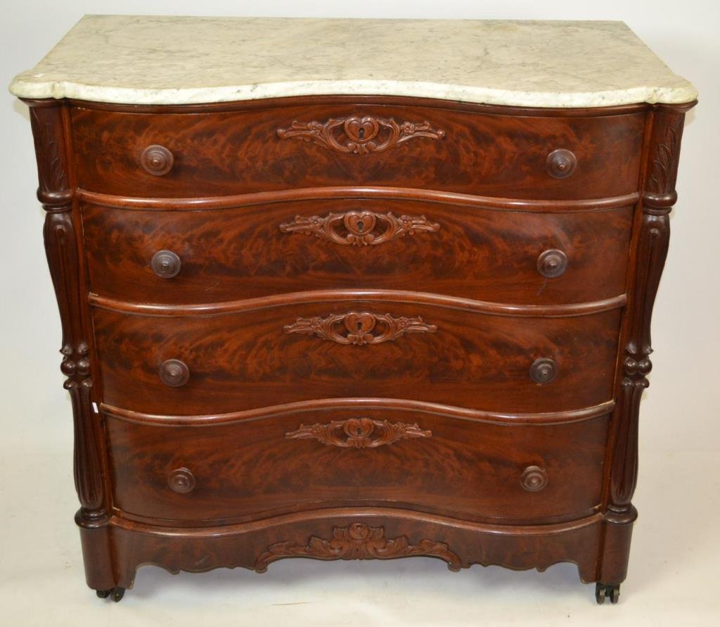 American Recoco Revival Ox-Bow Chest: American Roccoco Revival Ox-Bow Marble chest of drawers with wood pulls, heart shaped ornate carved escutcheons, crotch grain mahogany drawer fronts, measuring 41"h x 48" W x 21"D