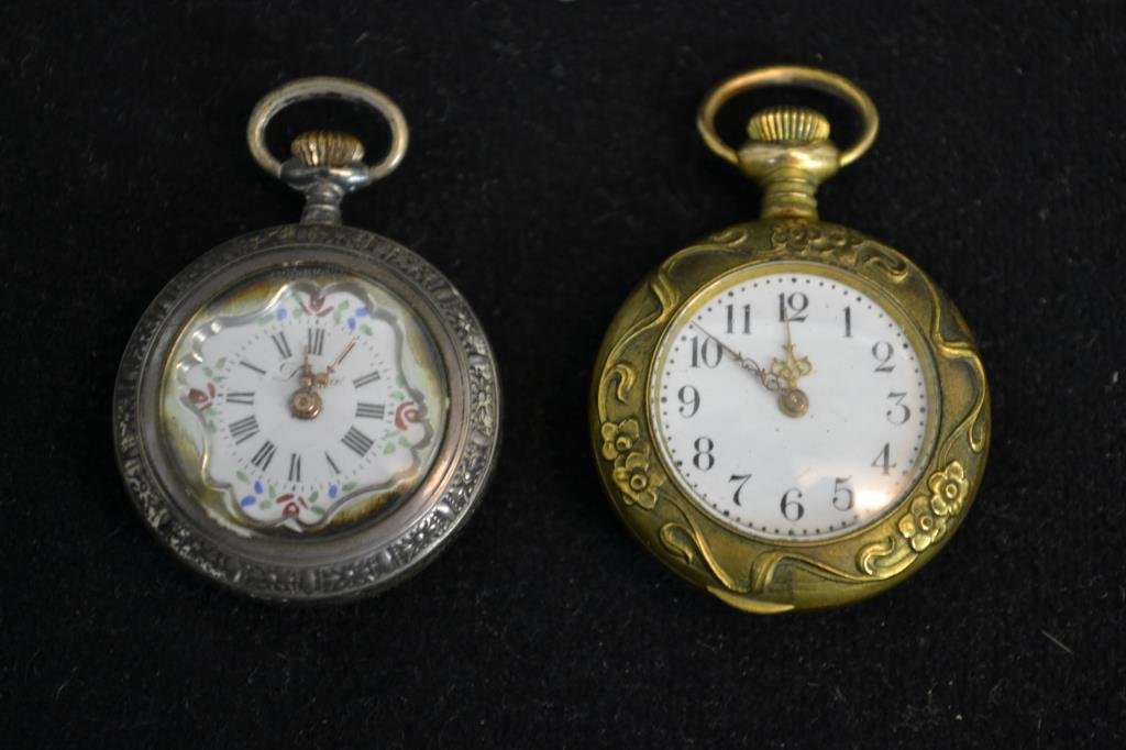 Two Ladies Watches With Ornate Gilt Cases: Diana ladies pendant watch with an ornate gilt case, has Swiss movement in silver case, and a New England WCO Cavour ladies watch with an ornate gilt case (balance staff is broken) each measuring appx