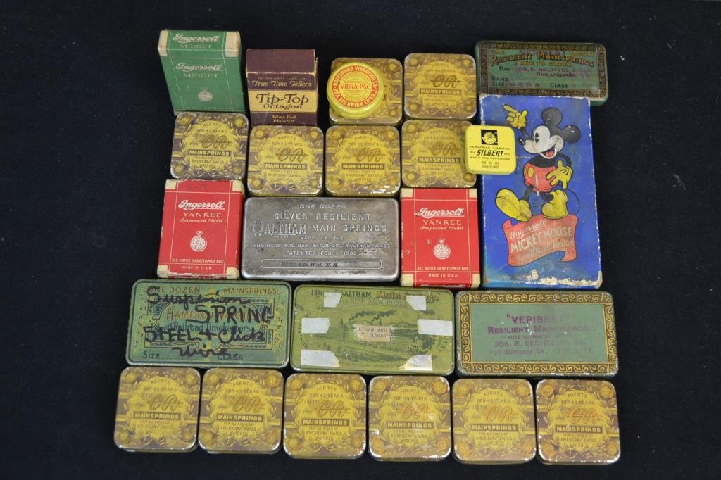 Collection of Early Clock and Clock Parts Tins and: Collection of mainspring tins and pocket watch boxes from C.R. Trademark, Tip-Top, Ingersol, and others (two trays) and an Ingersol Mickey Mouse wrist watch box