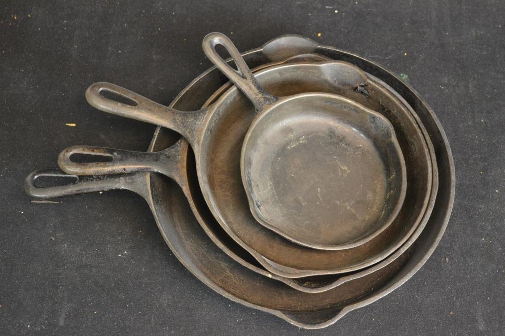 Grouping of Cast Iron Frying Pans: Grouping of Cast Iron frying pans including a 12" Grizwald, a 9Â½" unmarked frying pan, a Sidney 9" frying pan, and a Sidney #0 6 Â½" frying pan