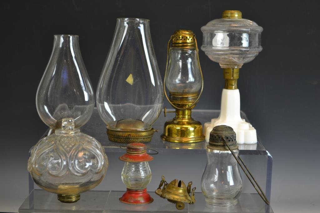 Grouping of Early Lighting: Grouping including a sandwich glass oil lamp with white base (vessel reservoir is cracked) comes with another reservoir, a Brass skater's lamp, a miniature skater's lamp, and various other parts