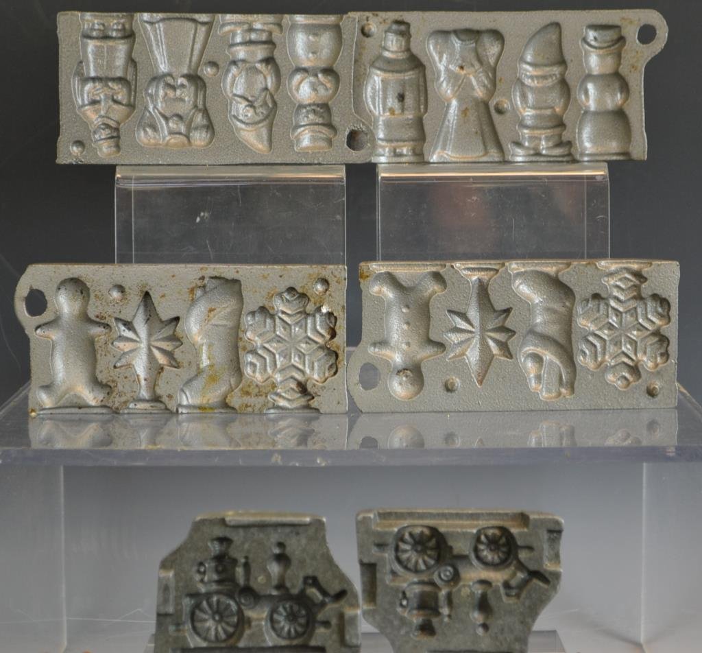 Early John Wright Candy Molds: Two early John Wright candy molds in the forms of Angles Elves and Snowmen, the other has Snowflakes, a Sttar, Sticking, and Gingerbread Man, and a third mold is an unrealted cast Fire Wagon