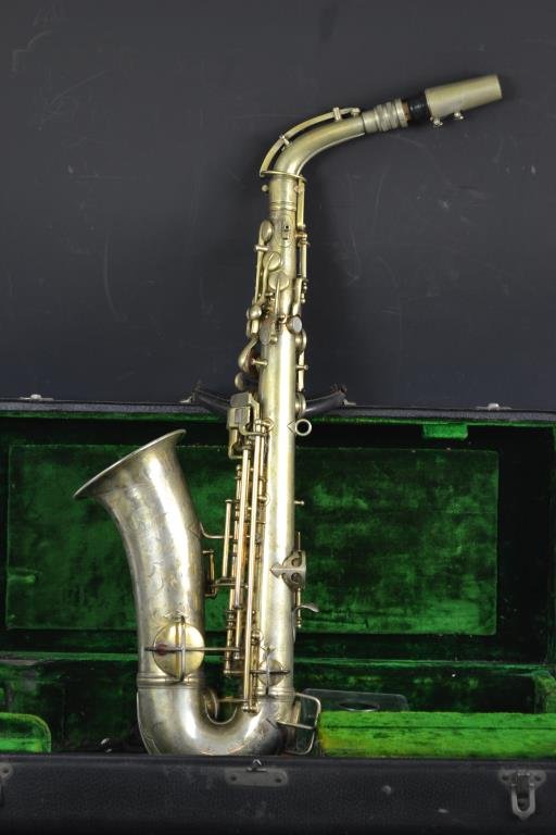 C.G. Conn Saxophone in Case: C.G. Conn Ltd Elkhart-Ind USA brass saxophone with silver plate, bearing a woman's portrait, December 1914 patent date, SN 1119954 - appx 24"H, 4 Â½" dia Bell