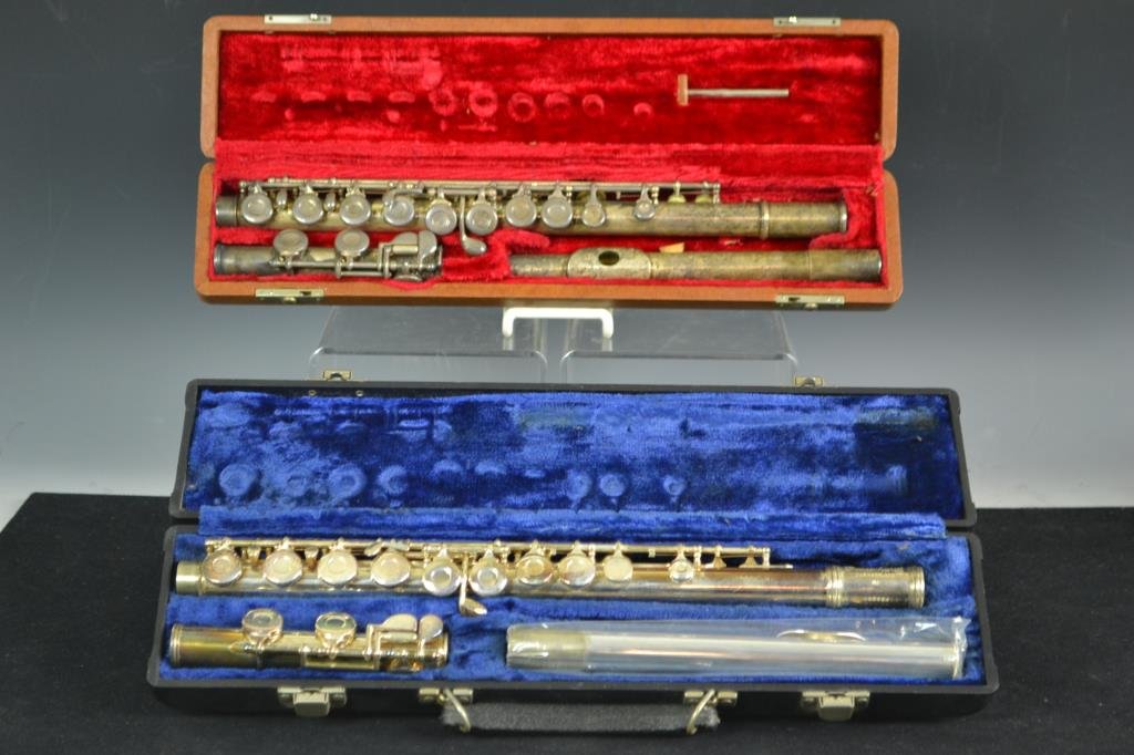 Two Flutes in Cases: Two flutes in cases; the first is a Gemeinhardt M2 flute in original black leather case SN C92894, and a GC Elkhart flute in case