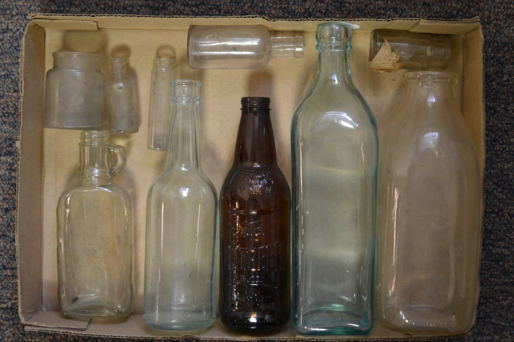 Grouping of Early Bottles: Grouping of early bottles including; Penn Supreme Milk bottle Lancaster, York, Ephreta, IBC Root Beer, Half Pint flask with handle, an inkwell, three ampules, and a small bottle