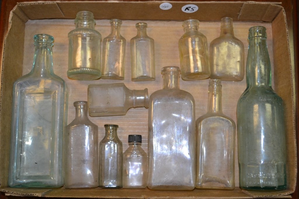 Collection of Bottles: Grouping of bottles including small apothecary bottles, one marked Wyeth, another marked 1/10th pint, an elixir bottle, and one marked Schmidt Bottle Inc "Capa City 12 oz" DOC 1111, and three smaller 
