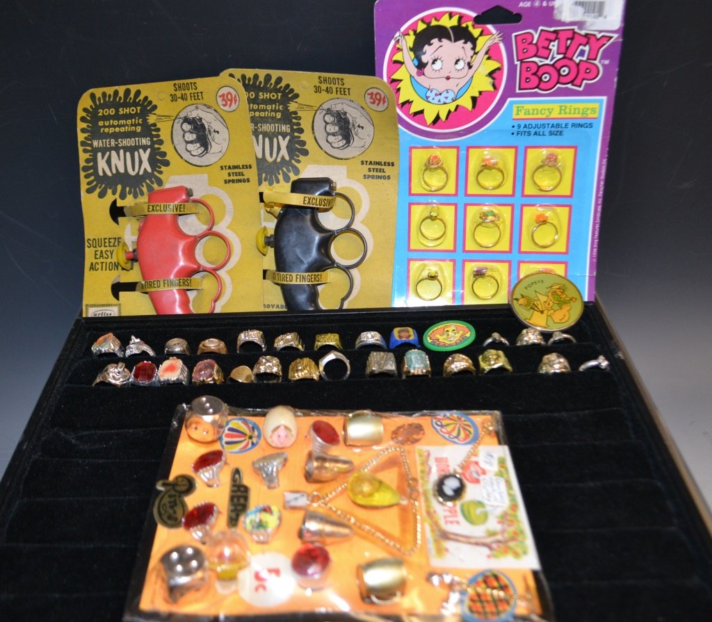 Large Collection Of Premiums & Gum Ball: Large Collection Of Premiums & gum ball items including; Betty Boop Fancy Rings, Squirt Gun Rings, and a Popeye belt buckle and more (appx. 20 rings)