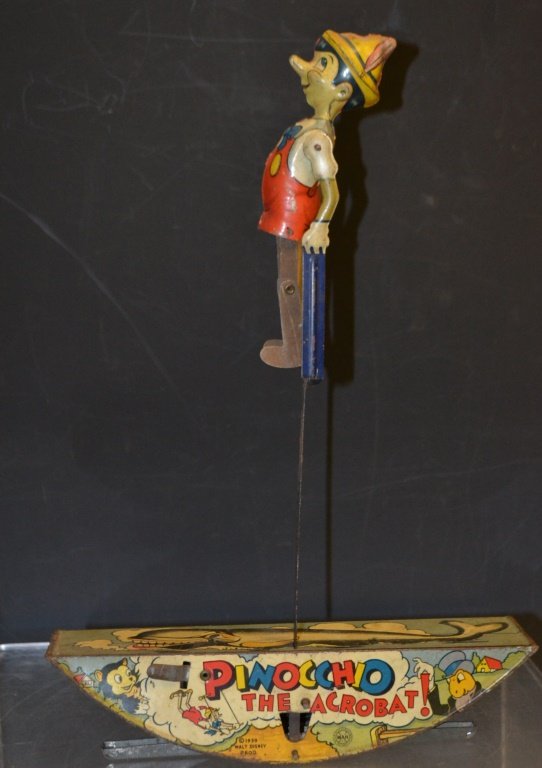 Tin Litho Marx Pinocchio Acrobat Wind-Up Toy: Tin Litho Marx Pinocchio acrobat wind up toy, in working condition, marked "1939 Walt Disney Prod." on base and has lithographed Pinocchio characters on base as well. Some scratching and wear througho