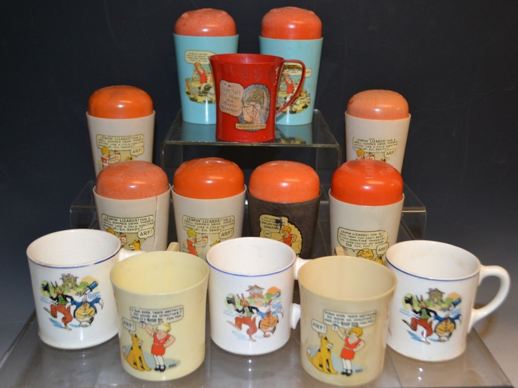14 Little Orphan Annie and Other Ovaltine Cups: 10 Little Orphan Annie, 3 Uncle Wiggily, and 1 Captain Midnight Ovaltine cups. Colors include red, light blue, brown, and white where 3 Uncle Wiggily mugs are ceramic and the rest are plastic. All are