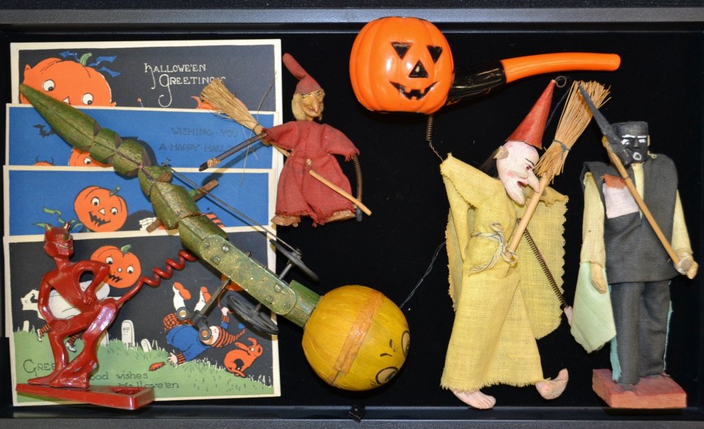 Collection Of Early Halloween Items: Collection of early Halloween Items including; early clock works pumpkin crawler 9"L, 4 post cards, Devil bottle opener and corkscrew, pumpkin pipe corn maker, 2 composite witches w/ spring arms.