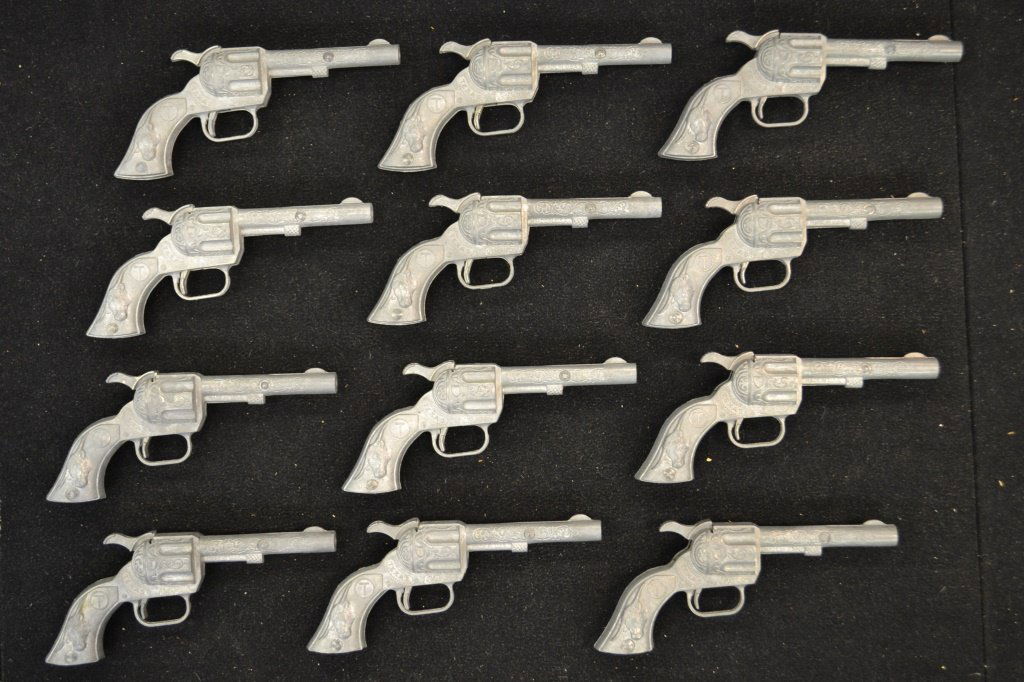 Twelve Texas Cap Guns: Grouping of twelve Texas cap guns, marked "made in the USA" with circle T and steer on grip, attributed to Hubley each measure 5.5"L