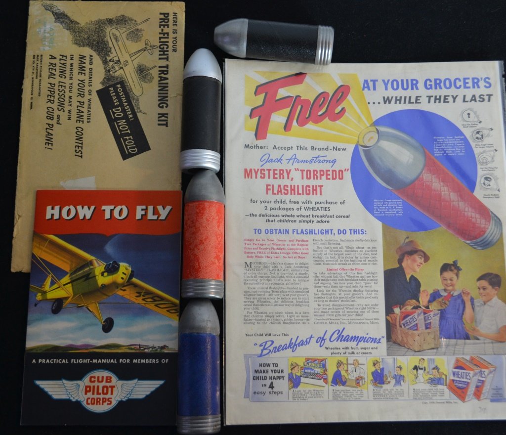 Grouping Of Jack Armstrong Premiums: Grouping Of Jack Armstrong Premiums including: (4) Mystery Torpedo flashlights, w/ original 1939 Wheaties advertisement, club pilot corps, How to fly pamphlet, original shipping envelope
